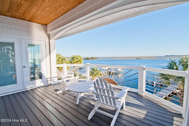 wooden deck featuring a water view