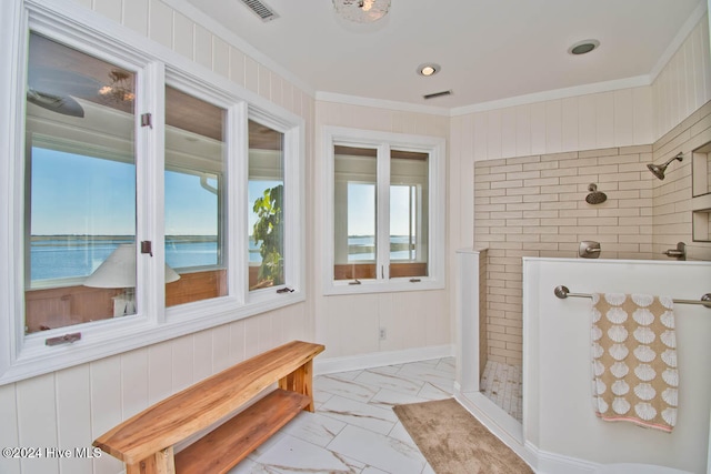 bathroom with a water view, ornamental molding, and walk in shower