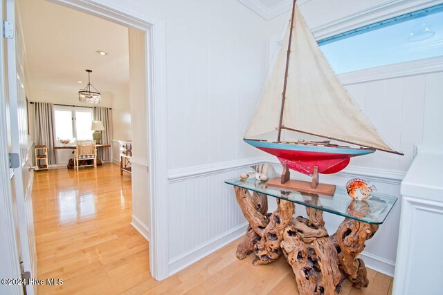 105 Wind Dance Ln, Swansboro, NC 28584 - detailed view of wood finished floors, a decorative wall, ornamental molding, a chandelier, and a wainscoted wall