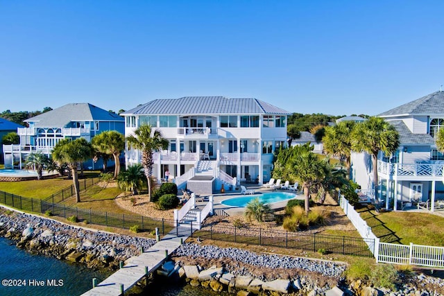 105 Wind Dance Ln, Swansboro, NC 28584 - rear view of house featuring a balcony, stairs, metal roof, and a water view