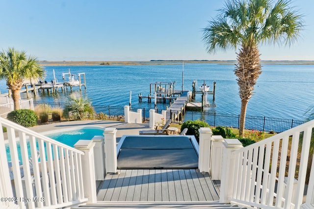 dock area with a patio and a water view