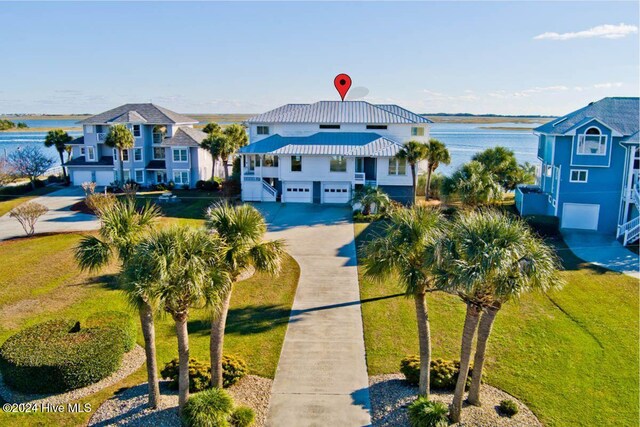 105 Wind Dance Ln, Swansboro, NC 28584 - view of front facade with a garage, a water view, stairs, and concrete driveway