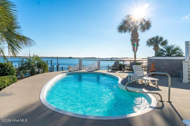 105 Wind Dance Ln, Swansboro, NC 28584 - swimming pool featuring a water view and a patio area