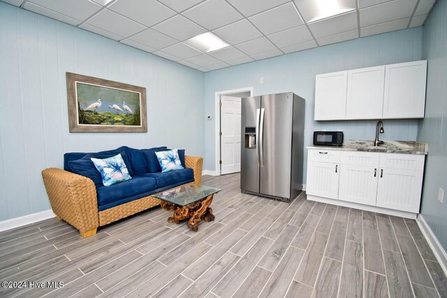 105 Wind Dance Ln, Swansboro, NC 28584 - living area with light wood-style flooring, baseboards, and a drop ceiling