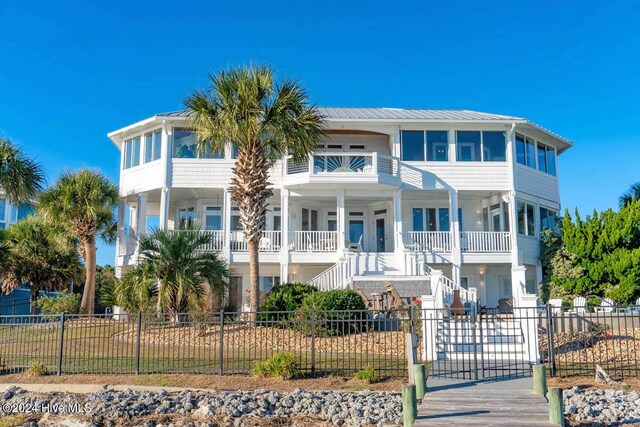 105 Wind Dance Ln, Swansboro, NC 28584 - view of front of house with stairway, covered porch, a fenced front yard, metal roof, and a standing seam roof