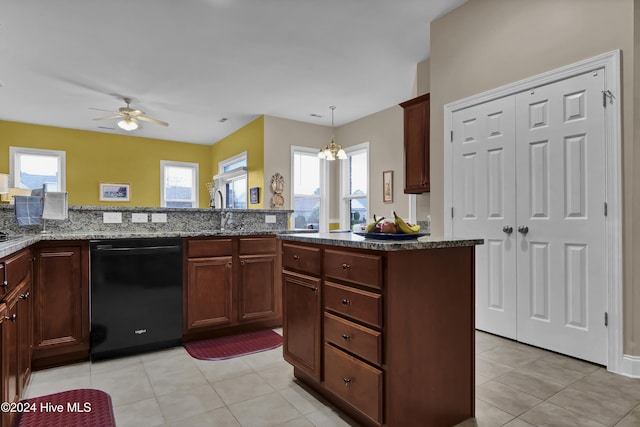 kitchen with black dishwasher, hanging light fixtures, a sink, and a wealth of natural light