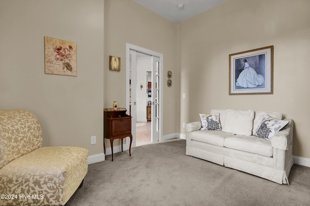 carpeted living room with baseboards