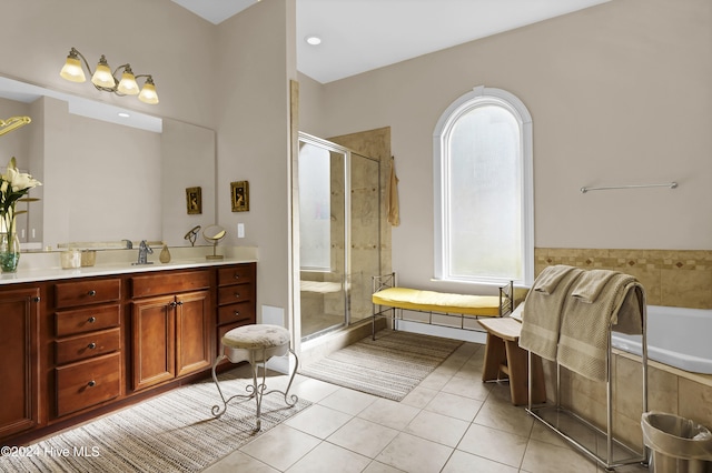 bathroom with a stall shower, vanity, and tile patterned floors