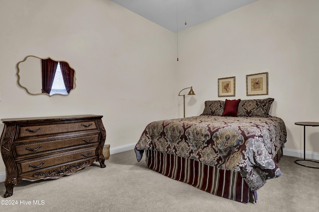 bedroom with light carpet and baseboards