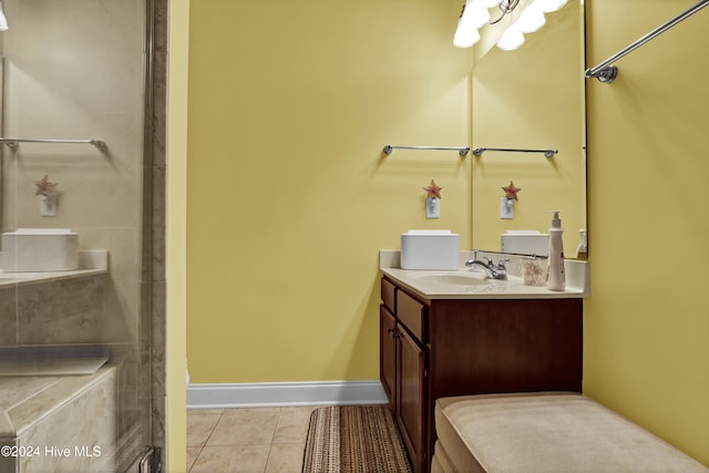 bathroom featuring tile patterned flooring, vanity, and baseboards