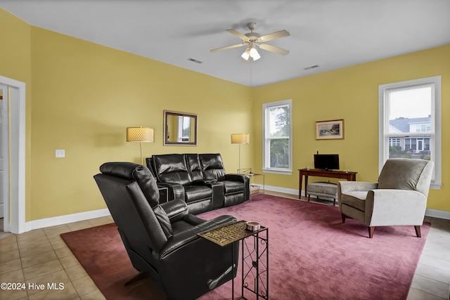 tiled living area featuring baseboards, visible vents, and a ceiling fan