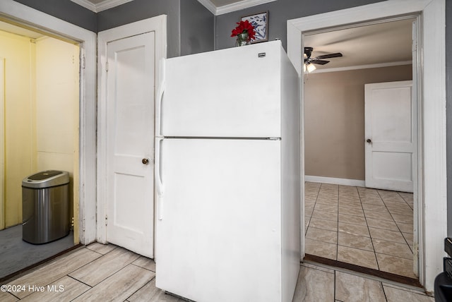 kitchen with ceiling fan, white fridge, light wood-type flooring, and crown molding