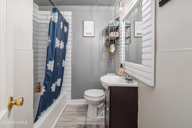 full bathroom with hardwood / wood-style floors, shower / bath combination with curtain, toilet, and vanity