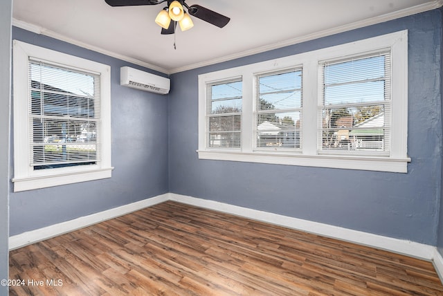 spare room with crown molding, ceiling fan, a wall mounted air conditioner, and hardwood / wood-style flooring