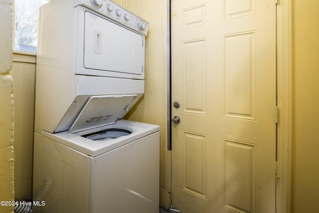 laundry room with stacked washer and clothes dryer