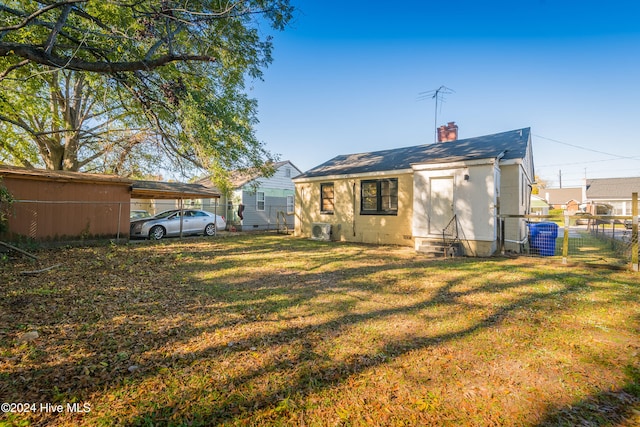 back of property with a lawn