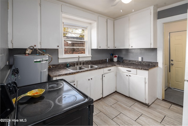 kitchen with white cabinets, black range, sink, ceiling fan, and water heater