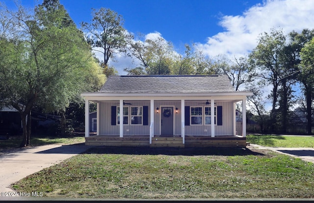 bungalow-style home with a front lawn and a porch