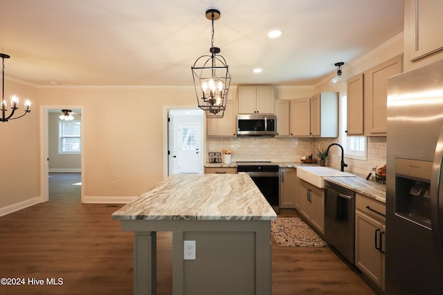 kitchen featuring appliances with stainless steel finishes, dark hardwood / wood-style flooring, ornamental molding, decorative light fixtures, and a kitchen island