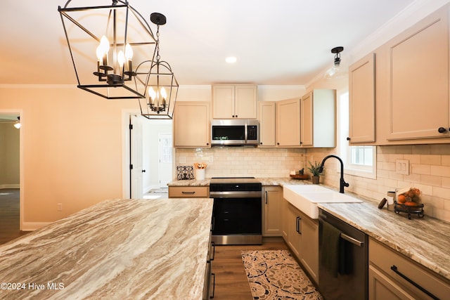 kitchen with sink, light hardwood / wood-style flooring, ornamental molding, stainless steel appliances, and a chandelier