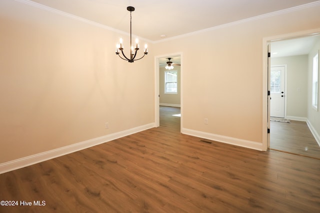 unfurnished dining area with crown molding, dark hardwood / wood-style flooring, and ceiling fan with notable chandelier