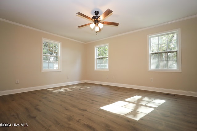 spare room featuring dark hardwood / wood-style flooring, ceiling fan, and crown molding