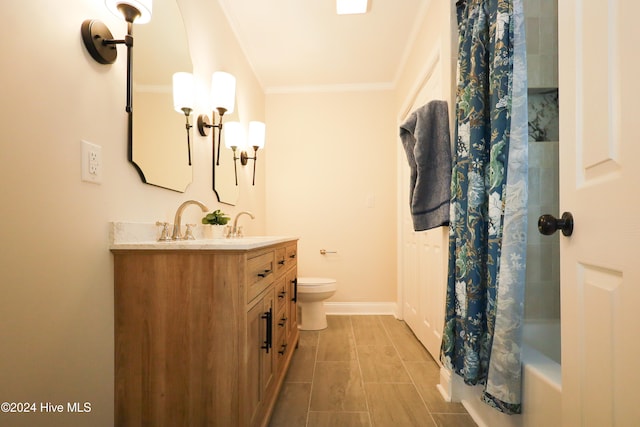 full bathroom with vanity, toilet, shower / bath combo with shower curtain, and crown molding