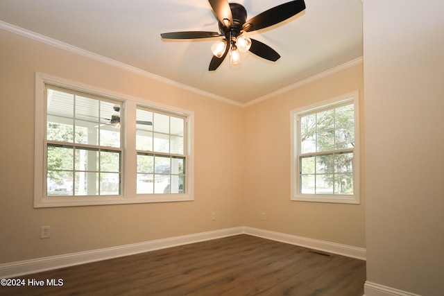 empty room with ceiling fan, dark wood-type flooring, and ornamental molding