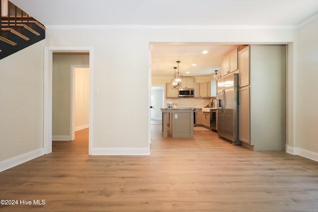 kitchen featuring decorative light fixtures, a kitchen island, light hardwood / wood-style floors, and stainless steel appliances