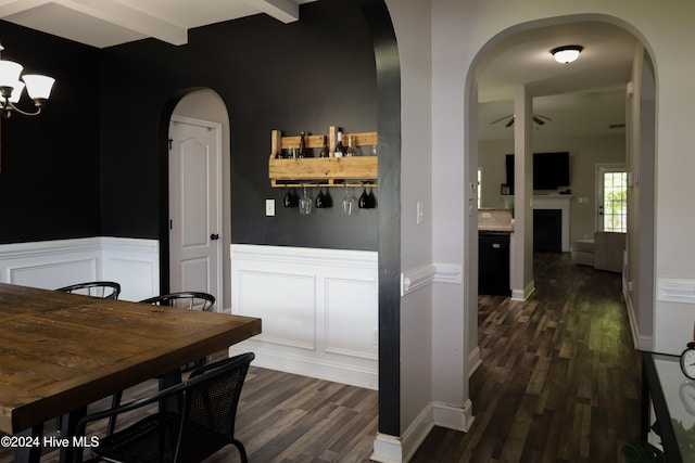 dining room featuring beam ceiling, ceiling fan, and dark hardwood / wood-style flooring