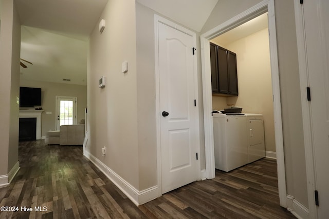 hallway with washer and dryer, lofted ceiling, and dark wood-type flooring