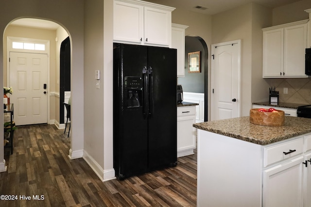 kitchen featuring white cabinetry, a center island, black appliances, and dark hardwood / wood-style floors