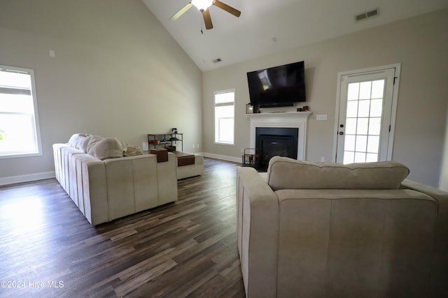 living room with dark hardwood / wood-style floors, ceiling fan, and high vaulted ceiling