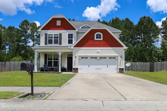 view of front facade featuring a porch, a front yard, and a garage