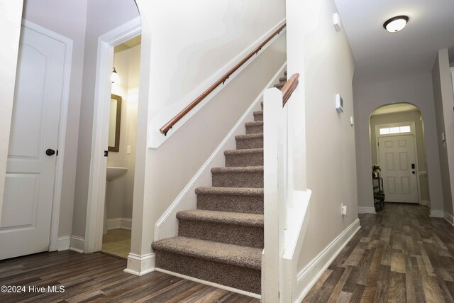 stairway with hardwood / wood-style flooring