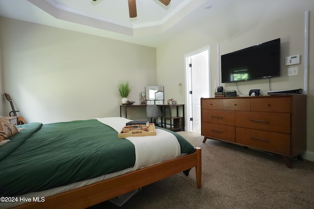 bedroom featuring carpet flooring, a raised ceiling, ceiling fan, and ornamental molding