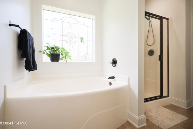 bathroom featuring independent shower and bath