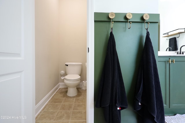 bathroom featuring tile patterned flooring, vanity, and toilet