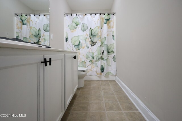 full bathroom with tile patterned flooring, vanity, toilet, and shower / bathtub combination with curtain