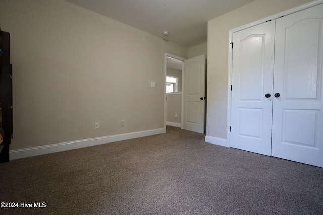 unfurnished bedroom with carpet and a closet