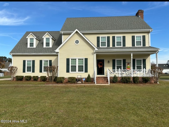 view of front of house with a porch and a front lawn