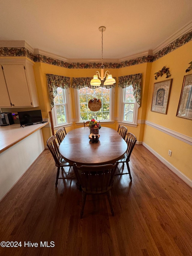 dining room with wood-type flooring, crown molding, and a chandelier