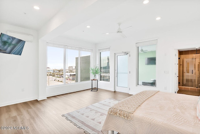 bedroom featuring ceiling fan, connected bathroom, access to outside, and light hardwood / wood-style flooring