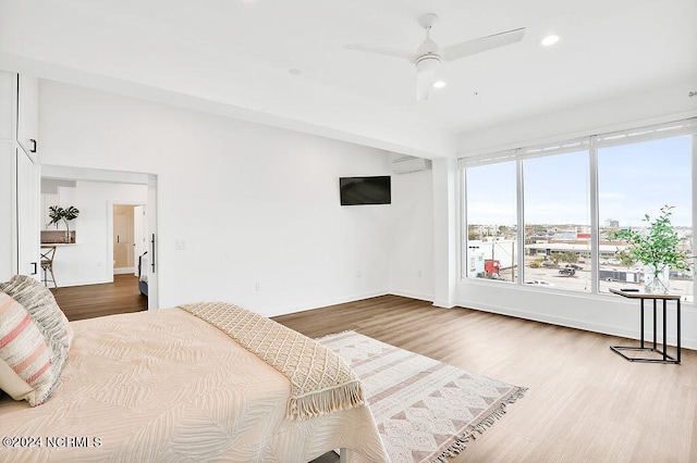 bedroom with ceiling fan and wood-type flooring