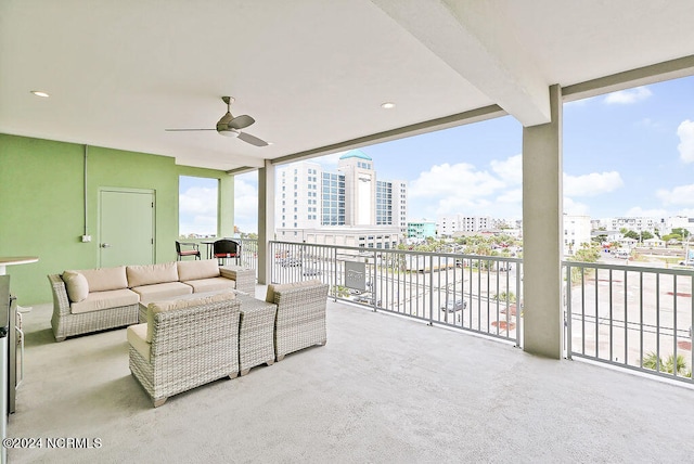 interior space with an outdoor hangout area, a balcony, and ceiling fan