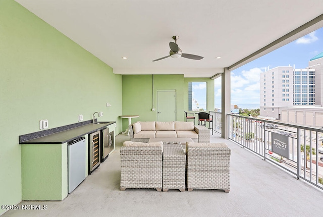 interior space featuring outdoor lounge area, ceiling fan, sink, and beverage cooler