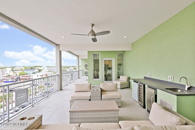 view of patio / terrace featuring an outdoor living space, ceiling fan, sink, and beverage cooler