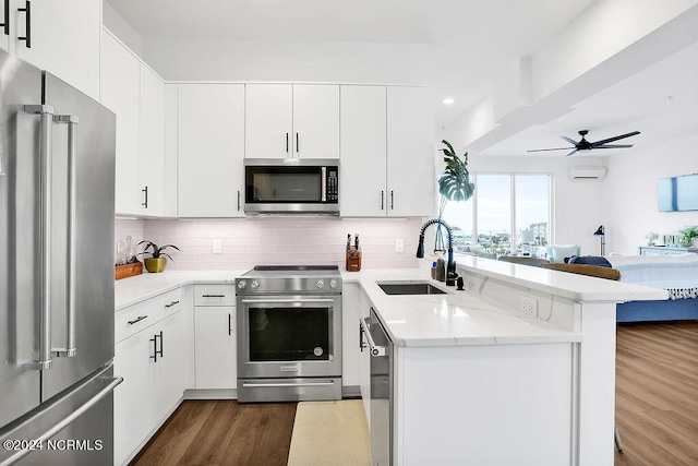 kitchen featuring sink, dark hardwood / wood-style floors, ceiling fan, white cabinetry, and stainless steel appliances