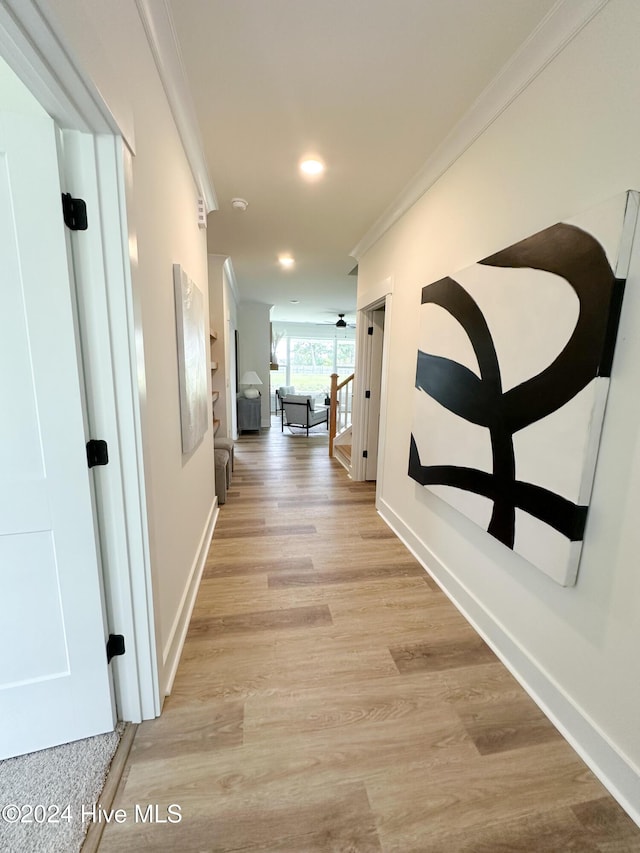 hallway featuring crown molding, recessed lighting, baseboards, and light wood-type flooring