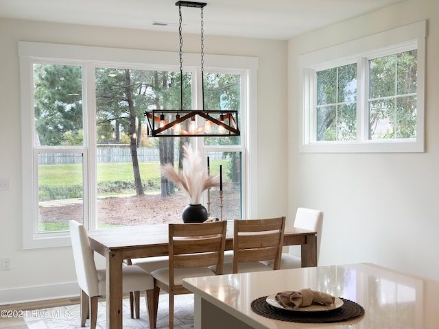 dining space featuring baseboards and wood finished floors